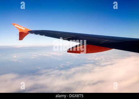 Left wing of an Airbus A319-100 of the easyJet airline, in flight