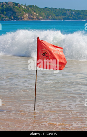 Red warning flag on the beach Stock Photo