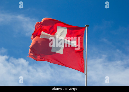 Swiss flag against blue sky Stock Photo