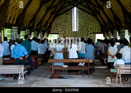 Believers attending a mass in a stone church, Insel Kvato, Alotau, Papua New Guinea Stock Photo