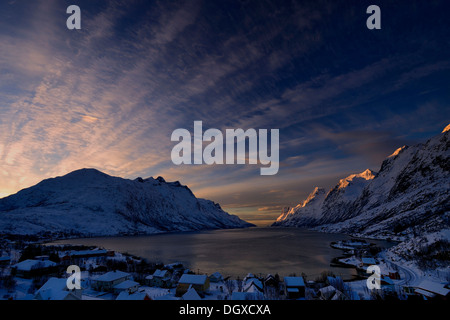 Fjord with small town in the evening light, Ersfjord, Tromsø, Troms, Northern Norway, Norway Stock Photo