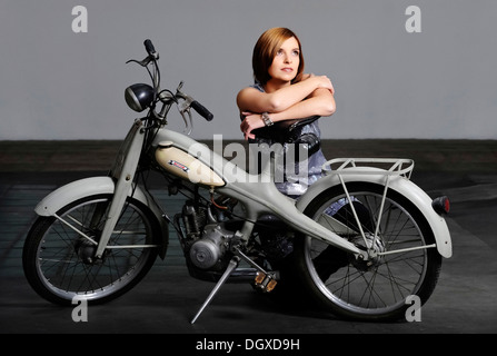 Young woman with a vintage Motom motorcycle Stock Photo