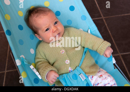 Portrait of little baby girl in a baby bouncer Stock Photo