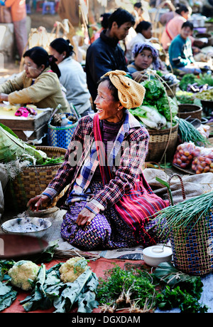 Smiling woman selling vegetables at a market in Myanmar, Burma, Southeast Asia, Asia Stock Photo