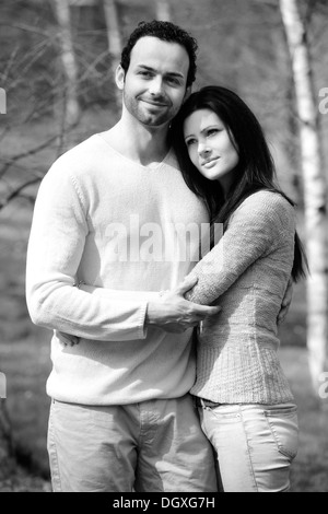 Young couple embracing, in a birch forest, Austria Stock Photo