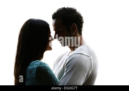 Young couple looking into each other's eyes, backlit, Austria Stock Photo