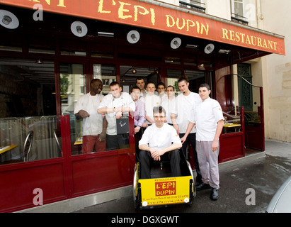 Service crew from the L'Epi Dupin restaurant, head chef Francois Pasteau seated in a wagon, 6th Arrondissement, Paris, France Stock Photo