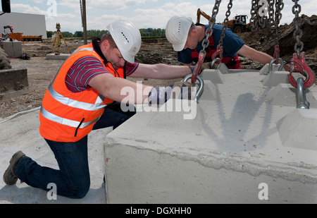 Structural engineers placing first blocks during a building site load test, at a construction site in Fridolfing, Bavaria Stock Photo