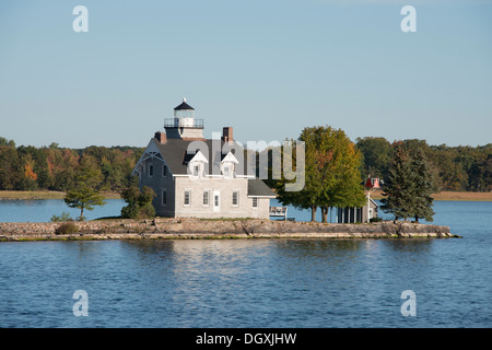New York, St. Lawrence Seaway, Thousand Islands. Home with lighthouse on tiny island. Stock Photo