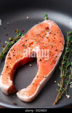 Salmon steak with thyme and pepper Stock Photo