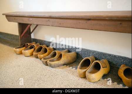 Dutch wooden clogs in the old hall with wooden bench Stock Photo