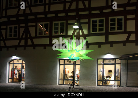 Light art, illuminated facade with star and display windows, long exposure, downtown, night-long shopping, Biberach a.d. Riss Stock Photo