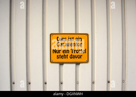 Sign in German not to block a garage door, 'this is a garage door, only a fool parks in front of it' Stock Photo