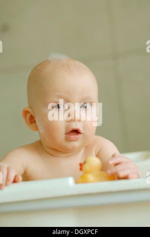 Baby in a bath with foam on his head Stock Photo