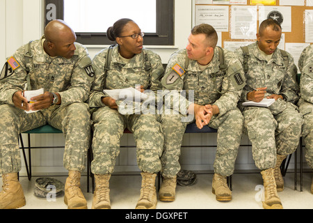 A women Drill Sergeant candidate sits among her male counterparts at the US Army Drill Instructors School Fort Jackson September 26, 2013 in Columbia, SC. While 14 percent of the Army is women soldiers there is a shortage of female Drill Sergeants. Stock Photo