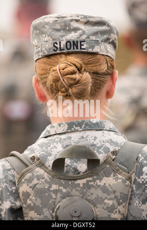 The hair bun of a female Drill Sergeant candidate show from under her hat at the US Army Drill Instructors School Fort Jackson during formation September 26, 2013 in Columbia, SC. While 14 percent of the Army is women soldiers there is a shortage of female Drill Sergeants. Stock Photo