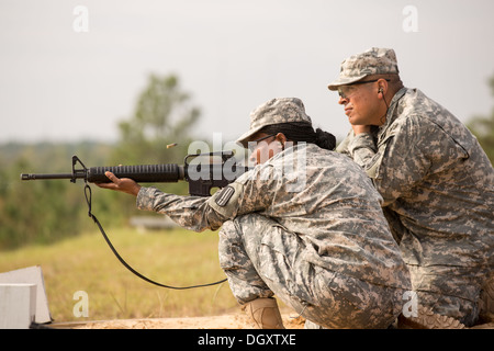 A woman Drill Sergeant candidate prepares to fire her rifle at the US Army Drill Instructors School Fort Jackson during weapons training September 26, 2013 in Columbia, SC. While 14 percent of the Army is women soldiers there is a shortage of female Drill Sergeants. Stock Photo