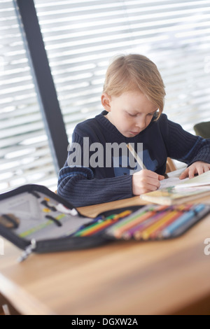 Schoolboy, 7 years, doing his homework, Germany Stock Photo