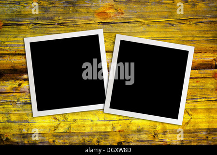 Blank photo frames over a wooden background Stock Photo