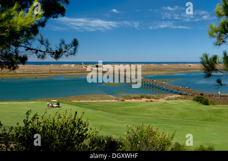 Portugal, the Algarve, Quinta do Lago, the wooden bridge to the beach in the Parque Natural de Ria Formosa, seen over the San Lorenzo golf course Stock Photo