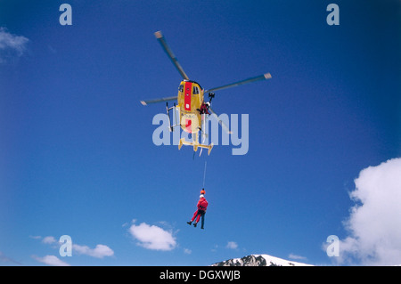 ADAC helicopter during a mountain rescue with a winch, Spitzingsee, Schliersee, Upper Bavaria, Bavaria, Germany Stock Photo