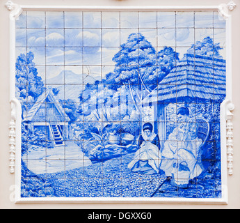 Azulejo, mural made of painted ceramic tiles, rural scene, two women sewing and stitching, on the local theatre in Funchal Stock Photo