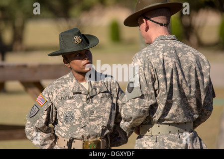 A female Drill Sergeant instructor observes candidates at the US Army Drill Instructors School Fort Jackson during close order drill exercises September 27, 2013 in Columbia, SC. While 14 percent of the Army is women soldiers there is a shortage of female Drill Sergeants. Stock Photo