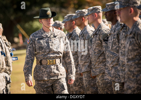 A female Drill Sergeant instructor observes candidates at the US Army Drill Instructors School Fort Jackson during close order drill exercises September 27, 2013 in Columbia, SC. While 14 percent of the Army is women soldiers there is a shortage of female Drill Sergeants. Stock Photo