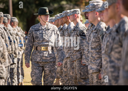 A female Drill Sergeant instructor observes candidates at the US Army Drill Instructors School Fort Jackson during close order drill exercises September 27, 2013 in Columbia, SC. While 14 percent of the Army is women soldiers there is a shortage of female Drill Sergeants. Stock Photo