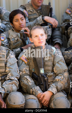 Female soldiers at basic combat training listen to instructions