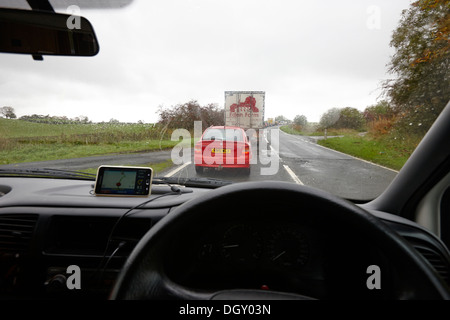 long queue of traffic on a75 single carriageway rural road near stranraer in scotland on a rainy day Stock Photo