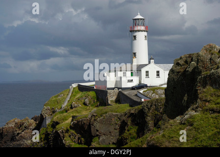 Fanad Head Lighthouse on rocky cliff, rain shower, County Donegal, Ireland, Europe Stock Photo