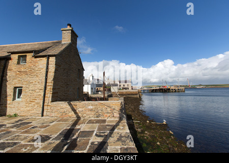 Islands of Orkney, Scotland. Fisherman’s cottages on Stromness’s waterfront, with the harbour in the background.