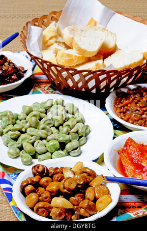 Spanish tapas selection of mushrooms, broad beans, lentils and fish with bread, Andalusia, Spain. Stock Photo