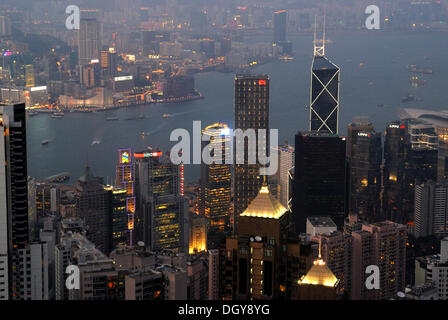 View from Victoria Peak on the nightly illuminated Hong Kong with skyscrapers and high-rise buildings of Central and Kowloon Stock Photo