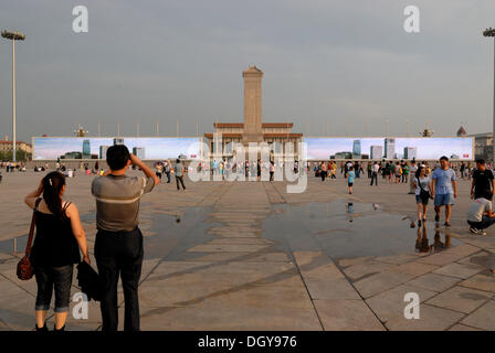 Chinese visitors standing in front of a huge multimedia presentation at the Mao Zedong Mausoleum on Tiananmen Square, Tianamen Stock Photo