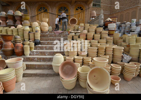 Kashgar crafts, Muslim Uighurs are offering their pottery and ceramics in front of an Uighur mud-brick house on the Kashgar Stock Photo