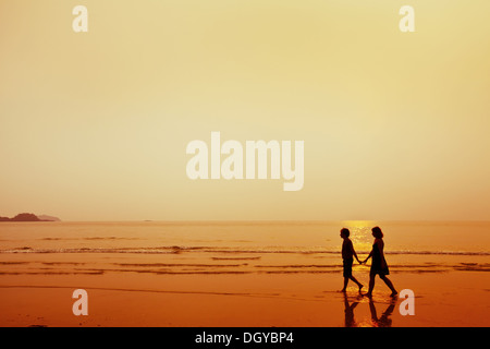 silhouette of couple on the beach Stock Photo