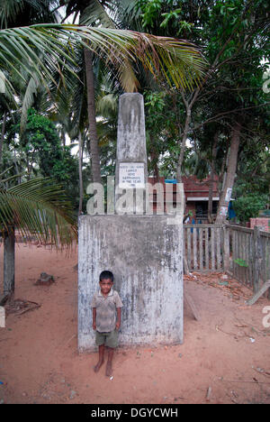 Little boy standing in front of a monument, place where Vasco da Gama went on shore, Kappad, near Kozhikode or Calicut, Kerala Stock Photo