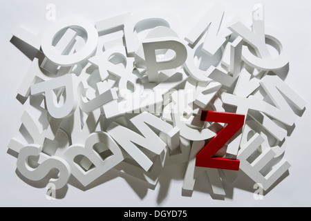 A heap of white block letters with a red letter Z Stock Photo