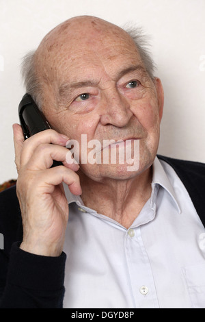 Portrait of a senior man making a phone call with a telephone Stock Photo