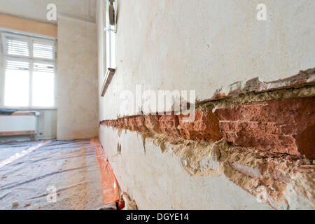Preparatory work on a wall for installing new cable canals and sockets, flush mounting, electrical wiring in an old building Stock Photo