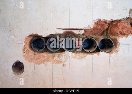 Preparatory work on a wall for installing new cable canals and sockets, electrical wiring in an old building, Stuttgart Stock Photo