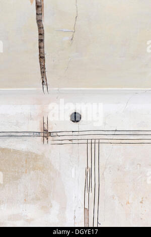 Preparatory work on a wall for installing new cable canals and sockets, electrical wiring in an old building, Stuttgart Stock Photo