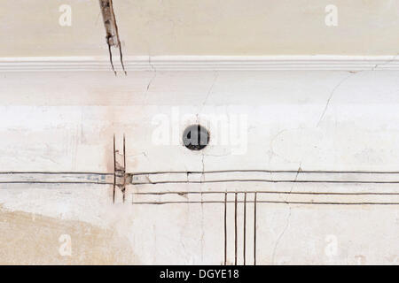 Preparatory work on a wall for installing new cable canals and sockets, electrical wiring in an old building, Stuttgart Stock Photo