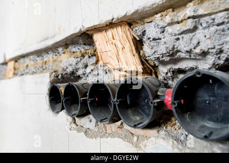 Preparatory work on a wall for installing new cable canals and sockets, flush mounting, electrical wiring in an old building Stock Photo