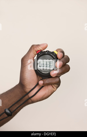 Man holding digital stopwatch Stock Photo