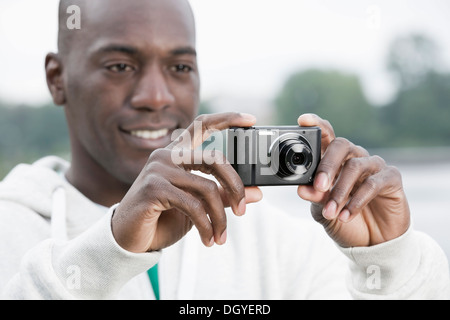 Man using digital camera Stock Photo
