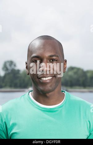 Portrait of smiling man in green t-shirt Stock Photo