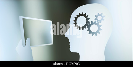 Graphic of a man in profile with a cogs in his head looking at a tablet Stock Photo